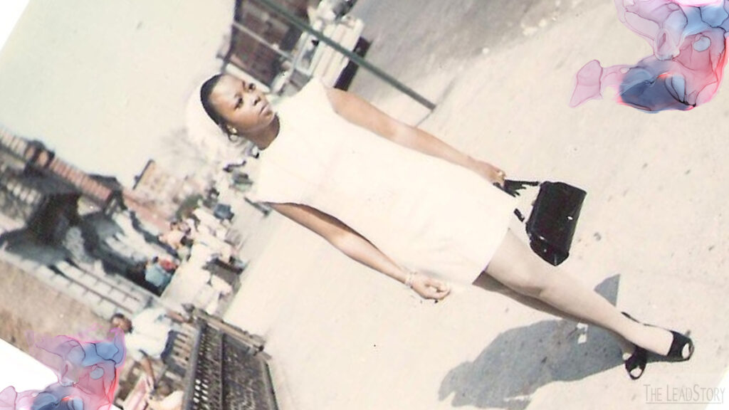 image of a woman standing on a city block dressed in white sheath capped sleeve dress